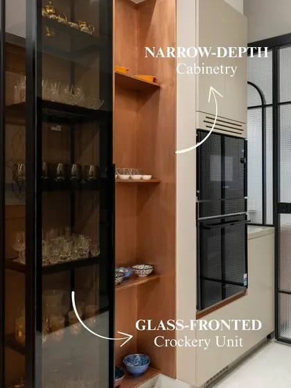 This tall unit features a glass-fronted crockery section and narrow-depth cabinetry, continuing the warm copper story from the rest of the kitchen. It’s a beautiful example of turning a structural element into a design feature.