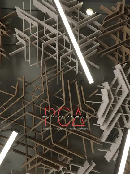 A detailed close-up of the interweaving acoustic ceiling panels designed for the StyleIn Homes office. This image highlights the complexity and artistic nature of the custom ceiling, which serves as a primary design feature while also providing functional sound dampening for the workspace.