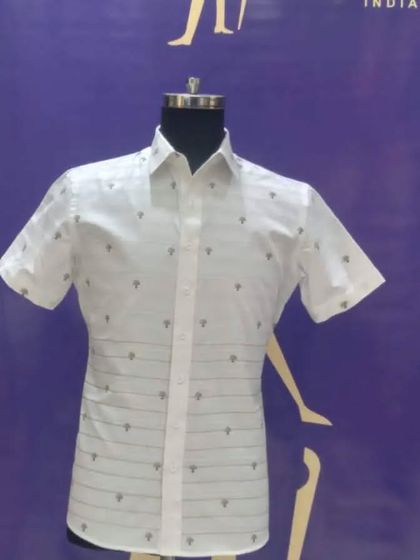 A custom white half-sleeve shirt with a subtle print and horizontal stripes. It's a modern and stylish option for casual wear.