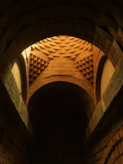The play of light and shadow within a brick vault at the Samyak Yoga Retreat. The geometric precision of the brickwork creates a dynamic visual effect, turning a simple structural element into a piece of art.