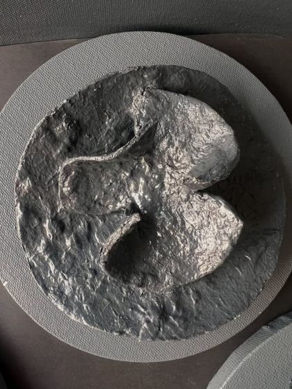 The texture in this piece is reminiscent of a butterfly or a blooming flower, a small world of its own.