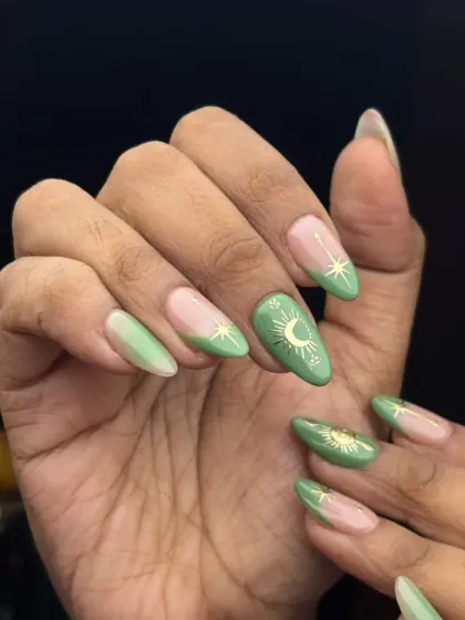 This celestial-themed manicure features a beautiful sage green base with delicate gold foil sun, moon, and star accents. It's a perfect example of the trendy, detailed nail art I love to create for my clients.