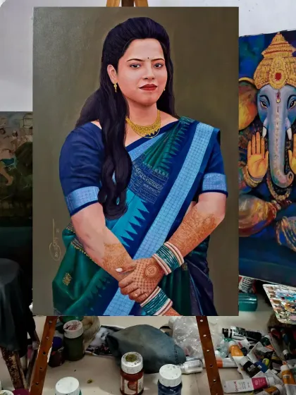 This image shows the custom portrait painting on an easel in my studio, next to a work-in-progress Ganesha painting. It gives a sense of the creative environment where these pieces are made.