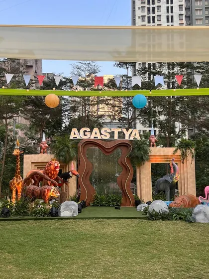 For this 'Wild Two' jungle themed birthday, we created a massive custom stage with marquee letters, a waterfall feature, and life-sized animal props to serve as the perfect backdrop for the celebration.