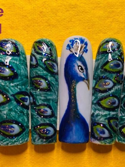 A close up of peacock themed nails for Janmashtami. The intricate feather details and use of glitter are advanced techniques I teach.