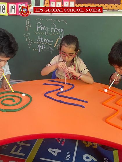 Three campers engage in a friendly competition with their play-dough mazes. Collaborative and parallel play activities like this foster social skills alongside cognitive and motor development.