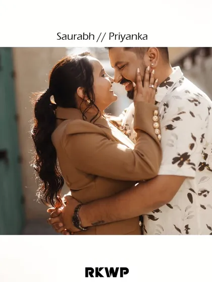 A stylish, graphic-style image from an urban pre-wedding shoot, capturing a joyful and intimate embrace in a city alleyway.