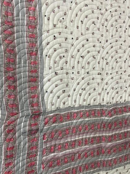 A detailed view of the quilting on the reversible saree quilt.