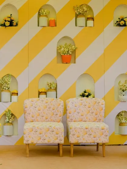 A detailed look at the Haldi backdrop, featuring arched niches with small floral arrangements, adding depth and elegance to the design.