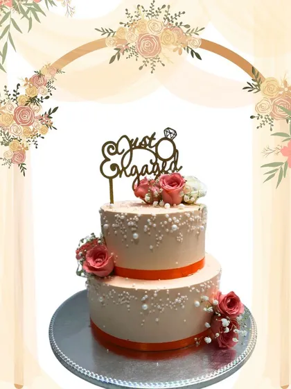Celebrating the beginning of a new journey, this two-tier engagement cake is both classic and elegant. I used delicate sugar pearls and fresh roses to create a romantic look, all baked fresh to order for the happy couple's special day.