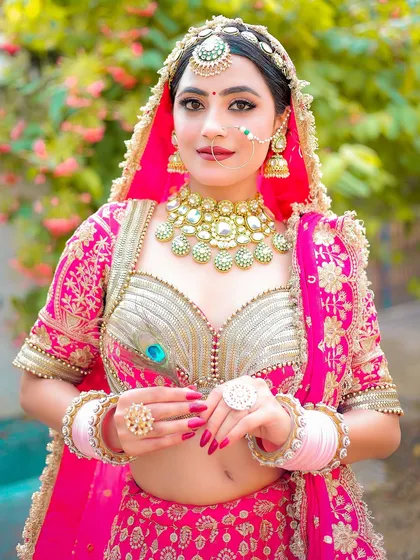 A direct and engaging bridal portrait that showcases the full set of jewelry and the beautiful henna details.