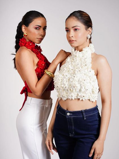 Here, I styled two models in textured halter tops to demonstrate product variations. The styling contrasts a bold red top with a delicate white one, showing versatility within a single collection.