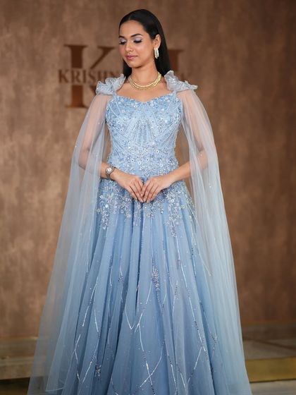 A modern, fashion-forward look featuring a pearl-encrusted gown. The simple diamond drop earrings are the perfect accessory for this statement outfit.
