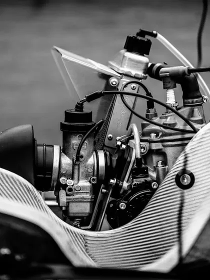 An artistic black and white shot of the Rotax engine and carburetor.