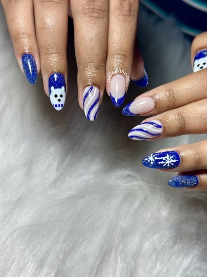 Another angle of these fun winter-themed Christmas nails. The combination of different patterns and textures makes this set so unique.