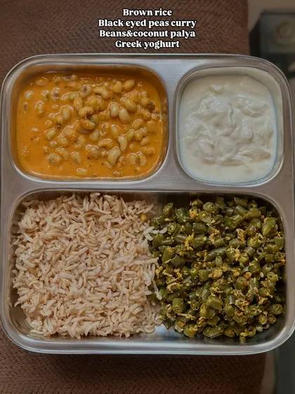 A simple vegetarian meal of brown rice, black-eyed peas curry, beans and coconut palya, and Greek yogurt. This plate is balanced and easy to prepare.