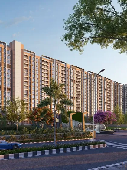 A street-level view of the entrance to Kohinoor Uptown in Kalyan. The design emphasizes a grand sense of arrival, with landscaped verges and a clear view of the modern residential towers.