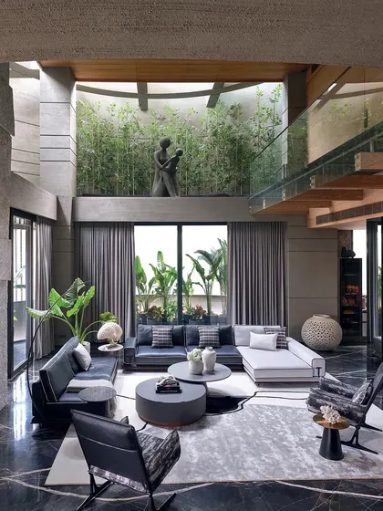 To bring nature inside, I designed this double-height living space around a central green courtyard. The large glass walls and open layout blur the line between indoors and outdoors, creating a sanctuary of calm and light.