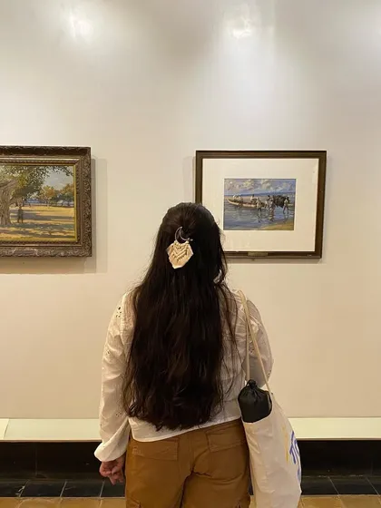 Our macrame moon clip worn at a museum, blending art with art. It's a versatile accessory that adds a touch of handmade elegance to your look.