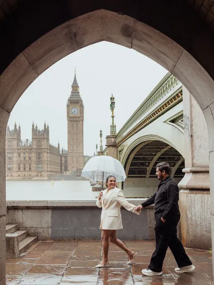 A classic London romance, complete with a little rain. We framed this shot through a stone archway, using the iconic Big Ben as a backdrop to create a timeless portrait that feels like a scene from a movie.