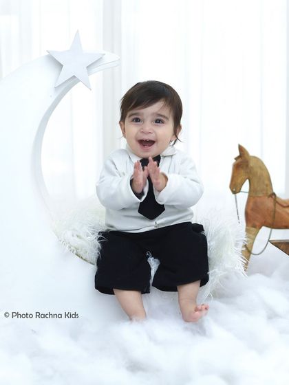 A joyful, clapping pose from the celestial moon shoot. We capture these happy, interactive moments that show your child's personality.