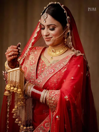 The bride looking down at her kaleere, a traditional and emotional moment captured with beautiful lighting.