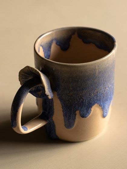 A beautiful mug with a drippy, layered glaze effect. Experimenting with glazes is one of the most exciting parts of the pottery process.
