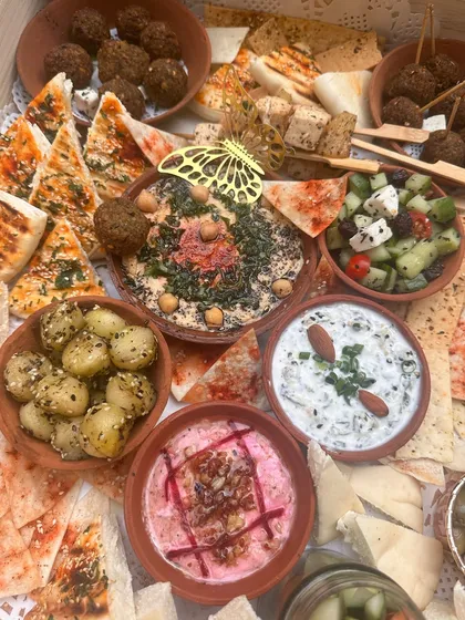 A top-down view of the complete Mezze platter, showing the generous portions and variety of items included.