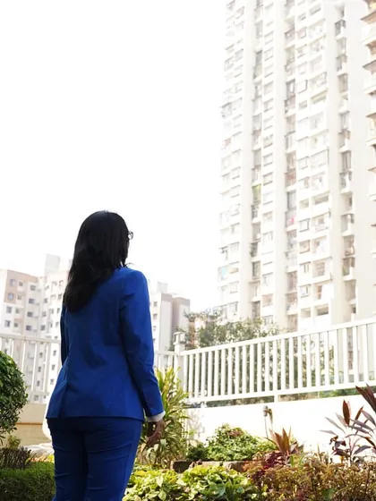 A photo of me looking up at a tall building. Words are magic. They can heal, inspire, and influence. This belief is the foundation of the India Authors Academy.