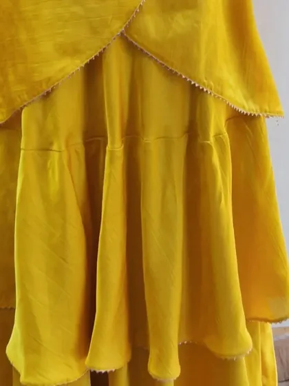 A detailed shot of the layered skirt for a custom Indo-Western lehenga. Each tier is carefully stitched to create a full, flowing silhouette that is both modern and festive.