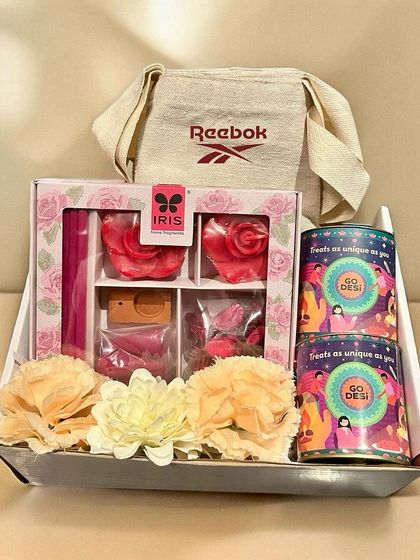 Another beautiful corporate hamper for Reebok, this one features a variety of local Indian sweets and snacks from Go Desi, fragrant potpourri, and a branded tote bag, all presented in a festive tray.