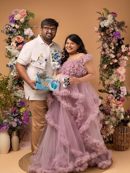 Celebrating their two little boys with a gift basket and tiny shoes. This is a wonderful way to personalize a twin maternity shoot.