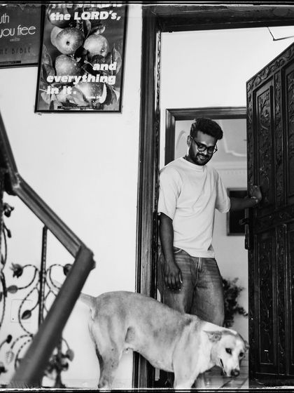 Dan and his dog. The composition uses the staircase to frame this gentle moment between a man and his best friend.