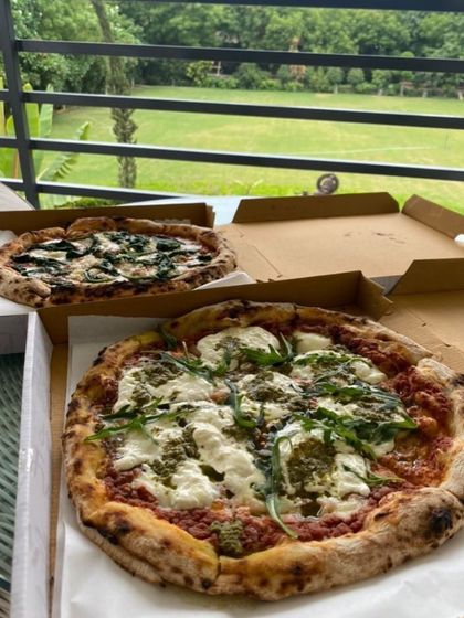 A rainy day calls for pizza. Here are two of my pizzas, a Pesto Burrata and a Ricotta and Spinach, ready to be enjoyed with a beautiful view.