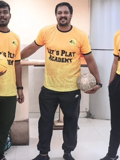 Three of our coaches ready with a basketball and football before a corporate event. We bring all the necessary equipment to turn any office space into a playing field.