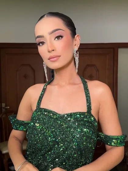 The model looking chic and powerful with her sleek updo, a testament to how a great hairstyle can elevate an entire look.