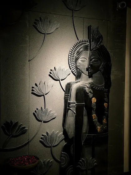 A close-up of our sculpted Radha Krishna panel. This isn't just a wall; it's a story, sculpted in stone to create a sacred and timeless centerpiece.