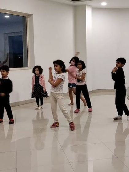 Another angle from our kids' dance class, showing how students mirror the instructor to learn the choreography.