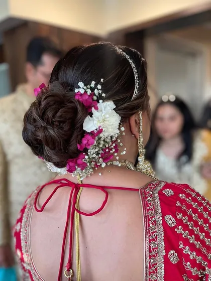 This angle shows how the floral arrangement follows the curve of the bun, creating a beautiful and cohesive look.