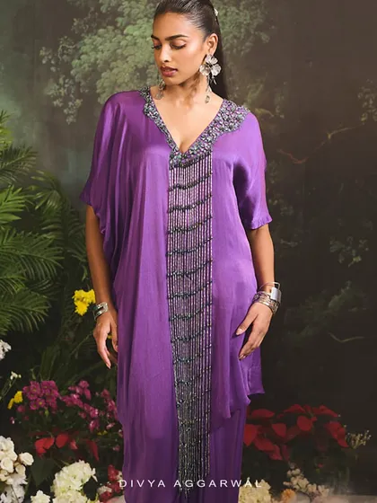 Immerse yourself in the intricacies of our Sage Kurta Set, featuring a draped skirt and a kurta with a heavily embellished neckline.