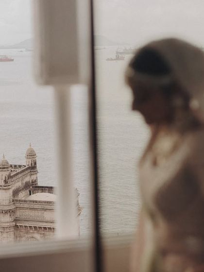 A dreamy, out-of-focus portrait of the bride with the Gateway of India in the background. This artistic shot plays with depth of field to create a sense of place and emotion.