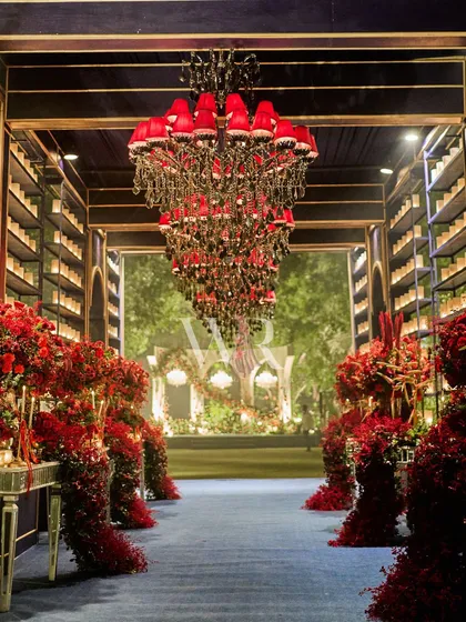 I love playing with bold color and contrast to create an unforgettable experience. This dramatic entrance tunnel, with its midnight blue carpet and walls lined with cascading red florals, guided guests into a world of passion and opulence.