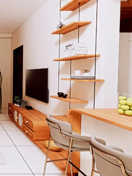 This view shows the open-plan living and dining area. A sleek breakfast bar connects to the kitchen, while floating shelves provide vertical storage, keeping the look light and airy.