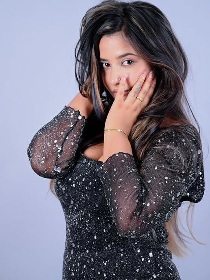 A soft, expressive portrait that showcases the model's delicate features and the sparkle of the dress.