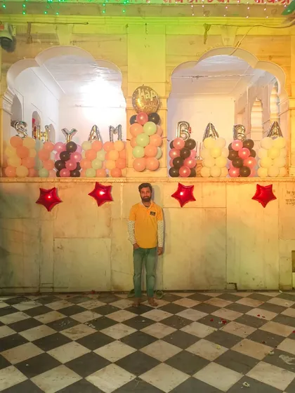 Another view of the balloon decoration inside the temple for Shyam Baba's birthday. The foil letters spell out "Shyam Baba" within the temple's arches.