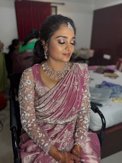 A close-up of Surya's reception makeup with her eyes closed. The shimmery eyeshadow and flawless base create a glamorous and polished look.