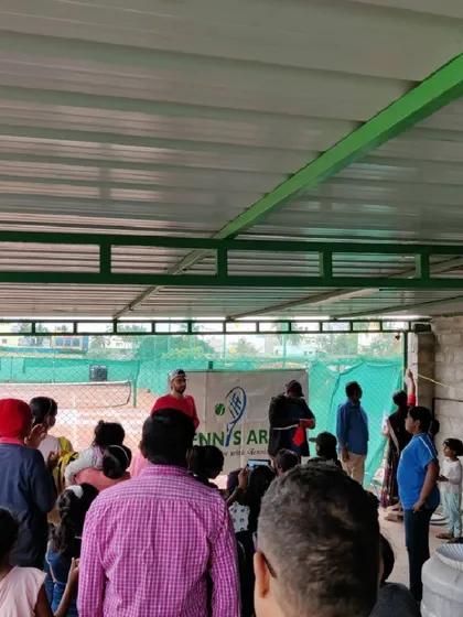 We are more than just courts; we are a community. Here, parents and players gather in our covered seating area during a beginners' tournament, creating a supportive and energetic atmosphere for everyone involved.
