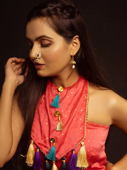 A close-up on the unique neckline and the traditional nose pin. This shot is all about the details.