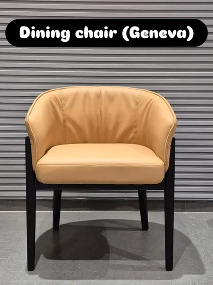 A front view of the 'Geneva' dining chair, highlighting its plush seat and enveloping backrest.