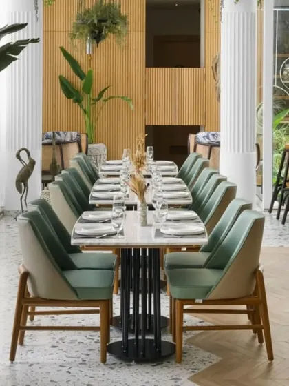 This view of the Elina Vara brasserie showcases my passion for biophilic design. I brought the outdoors in by using natural wood, lush greenery, and a light color palette to create a dining space that feels fresh and serene. The design connects directly to the restaurant's farm-to-fork philosophy, offering guests a tranquil escape in the city.